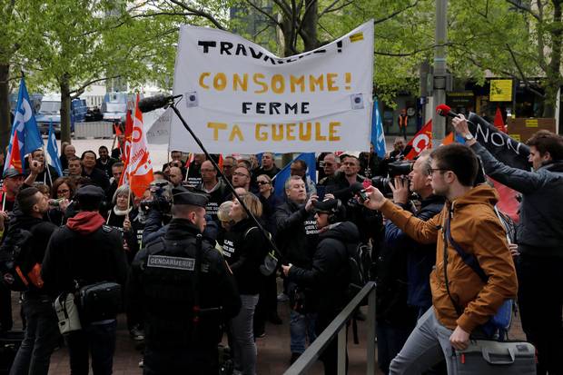 Whirlpool Amiens factory union employees demonstrate outside the company headquarters at the financial and business district of La Defense, west of Paris.