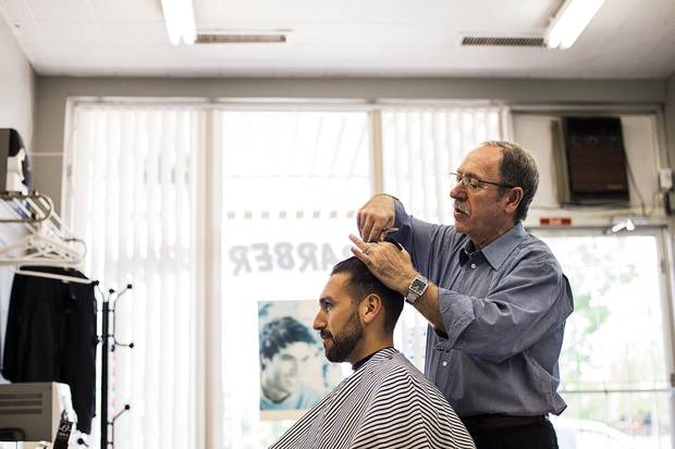 Joe Barillari gives Dan Ahumada a trim at his barber shop, which was built more than 65 years ago and is one of the oldest in Mississauga.