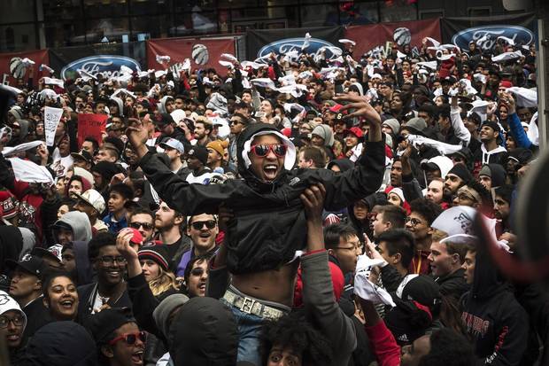 Toronto Raptors fans are celebrate outside the Air Canada Center after the team's game 7 win against the Miami Heat in Toronto on Sunday, May 15, 2016.