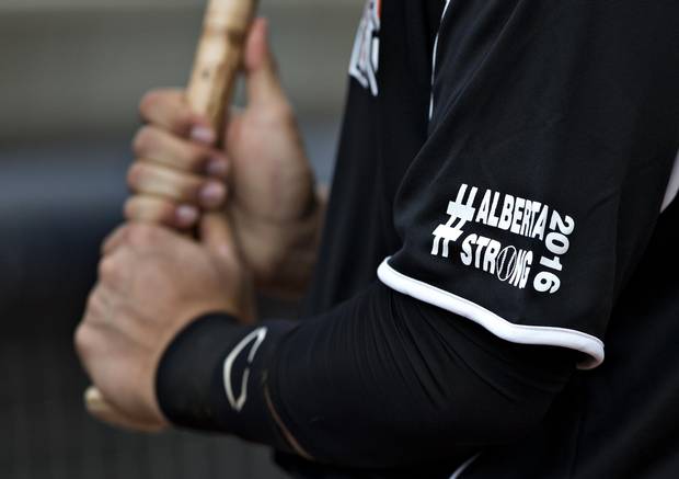 A Fort McMurray Giants player wears Alberta Storng on his sleeve in support of the Fort McMurray wildfires while taking on the Edmonton Prospects in Edmonton on May 28, 2016. It's the Giants first game in their borrowed stadium since the wildfires in Fort McMurray.