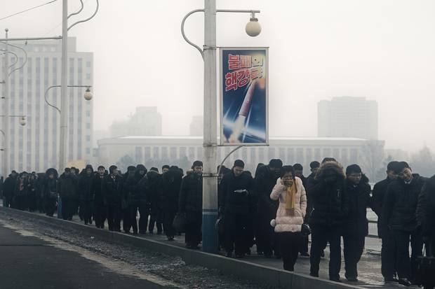Crowds stream across Pyongyang’s Okryu Bridge from a medal ceremony held to fete the nuclear scientists responsible for engineering North Korea’s internationally condemned Nov. 29 intercontinental ballistic missile launch.