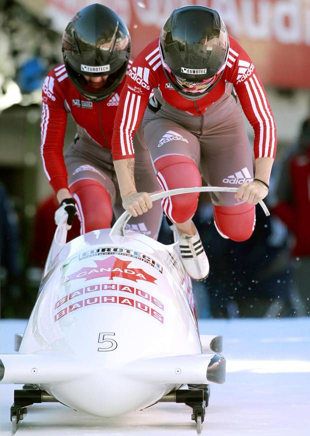 Canada's pilot Kaillie Humphries (R) and brakewoman Chelsea Valois start on the natural ice track during the first run of the two-women competition at the FIBT Bobsleigh and Skeleton World Championships 2013 on Jan. 25, 2013.