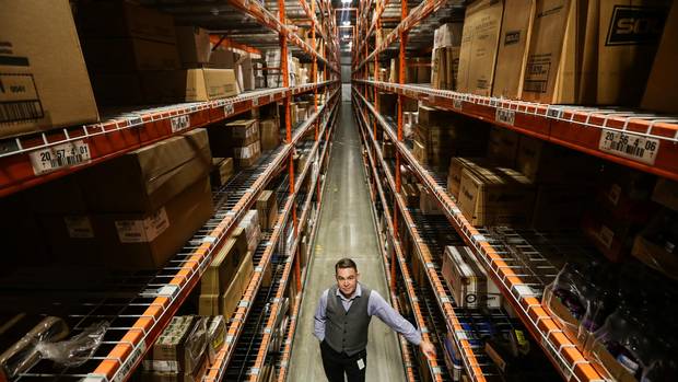 Barry Reid, Flanagan’s vice-president for sales and marketing, stands in the company’s warehouse distribution centre in Kitchener, Ont. The company has an inventory of about 10,000 warehoused products.