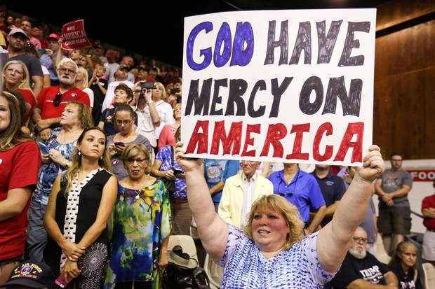 A supporter holds up a sign as Republican presidential nominee Donald Trump speaks during a campaign rally in Sarasota, Fla., on Nov. 7, 2016.