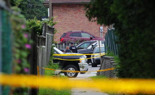 Police gather evidence outside of a house in Strathroy, Ont., on Thursday. Terrorism suspect Aaron Driver was killed in a confrontation with police in the town the day before.