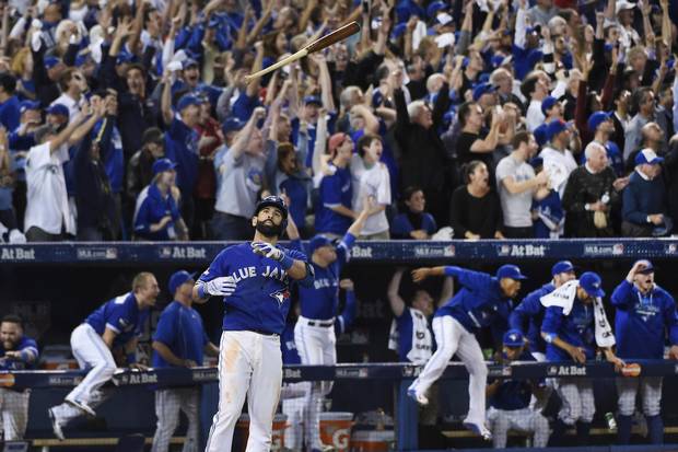 Blue Jays outfielder Jose Bautista flips his bat into the air after hitting a three-run homer in the seventh inning against the Texas Rangers in Game 5 of the American League Division Series on Oct. 14, 2015 in Toronto.