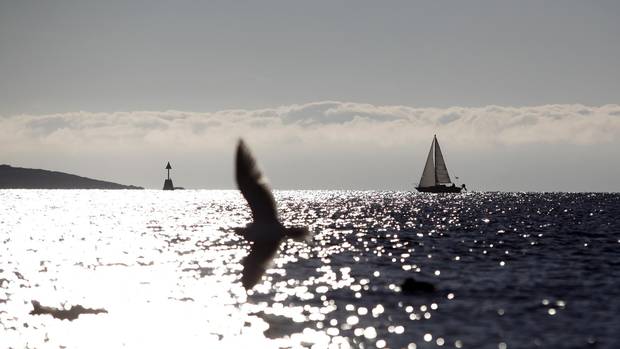 A sailboat passes through the Strait of Juan de Fuca off Victoria. The strait would see a significant increase in oil tankers if Kinder Morgan’s Trans Mountain pipeline expansion is approved.