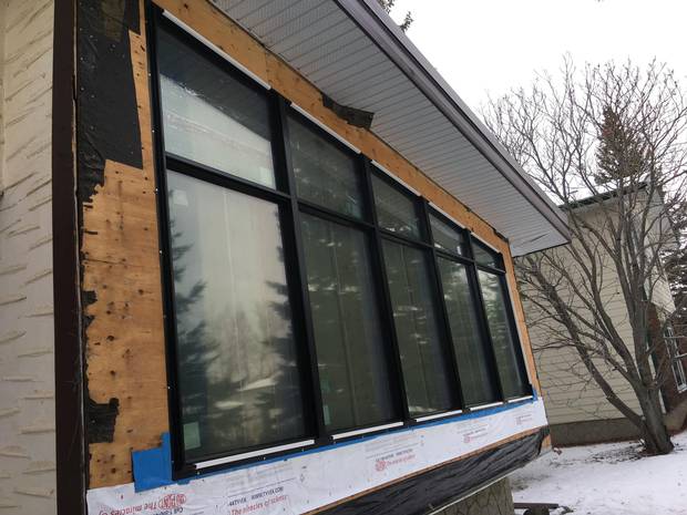 A new picture window is being installed.