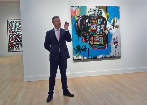A Sotheby’s official speaks about an untitled painting by Jean-Michel Basquiat during a media preview on May 5 in New York.