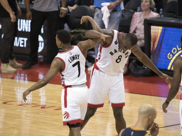 Toronto, Ontario, CAN; Toronto Raptors center Bismack Biyombo (8) celebrates a basket with Toronto Raptors guard Kyle Lowry (7) during the fourth quarter in game four of the Eastern conference finals of the NBA Playoffs against the Cleveland Cavaliers at Air Canada Centre. The Toronto Raptors won 105-99.
