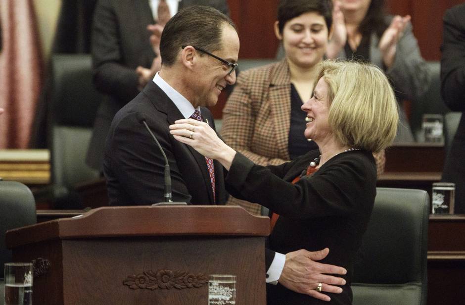 Alberta Finance Minister Joe Ceci and Alberta Premier Rachel Notley embrace after tabling the 2017 provincial budget in Edmonton on March 16, 2017.