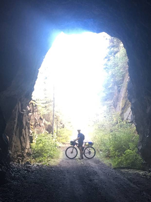 Steve Bloom is shown with his mountain bike, laden with camping gear, on Sept. 10 along the trail between Midway and Grand Forks.