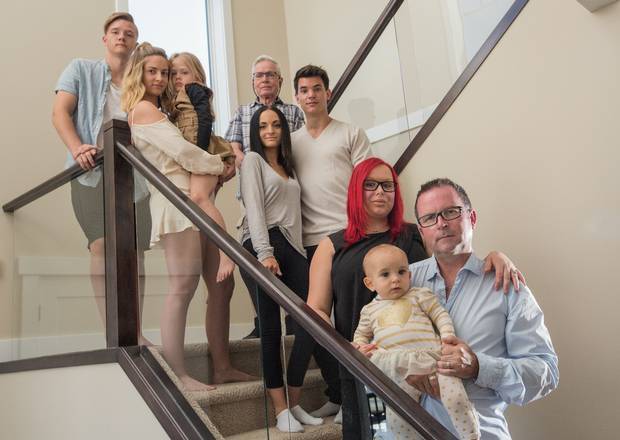 Shawn Beaver at home with his family in Edmonton, Alberta. Mr. Beaver's baby daughter, who he is holding in this photograph, was one week old when his life changed. 