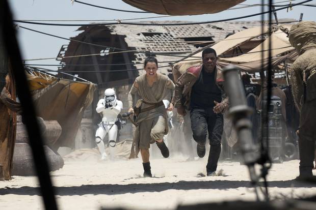 Daisy Ridley and John Boyega star in Star Wars: The Force Awakens, which comes out Dec. 18.