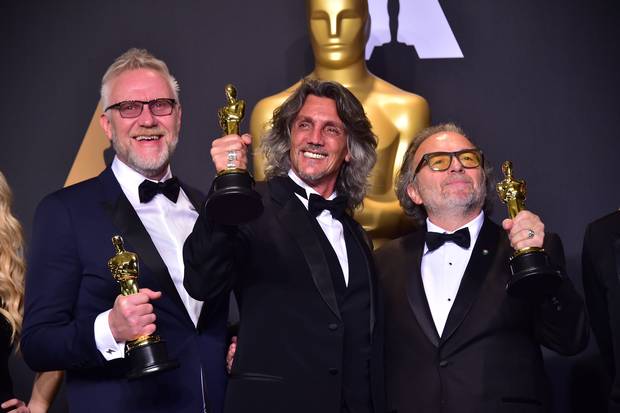 Alessandro Bertolazzi (R), Giorgio Gregorini (C) and Christopher Nelson (L) poses with the Oscar for Best Makeup and Hairstyling in the press room, during the 89th Oscars on February 26, 2017, in Hollywood.