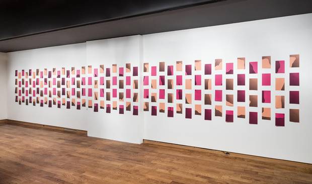 Visitors have to walk around the space to decipher the message in Raymond Boisjoly's tiled piece.