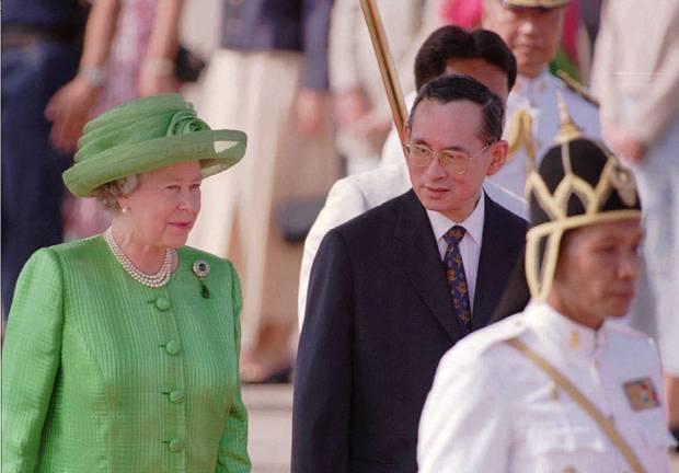 Thailand’s King Bhumibol Adulyadej chats with the Queen in Bangkok on Oct. 28, 1996.