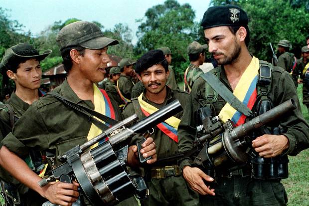 FARC fighters pose with their weapons after a patrol in the jungle near the town of Miraflores on Aug. 7, 1998.