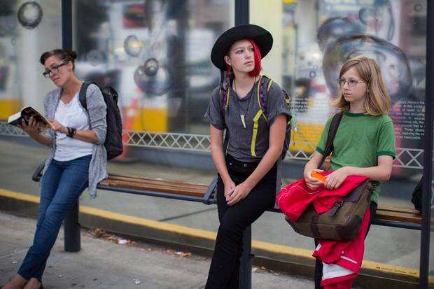 Eliana Gaertner, 14, and her brother Rowan, 12, wait for the city bus to take them to school in Vancouver.