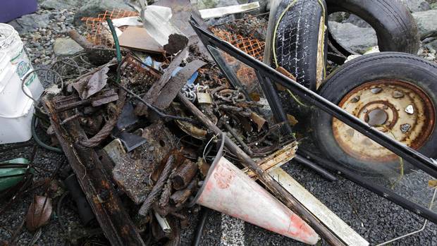 A pile of scrap metal, chains, tires, a pylon, boat window, plastic fencing, and a garden hose are some of the items found during the Surfrider Pacific Rim Christmas Jingle Cleanup Event along the Tofino harbour shorefront near the 4th Street government dock and marina on December 2, 2016.