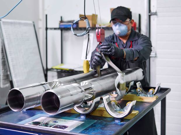 A worker at Toronto's Triumph Gear Systems crafts shield plugs for end fittings.