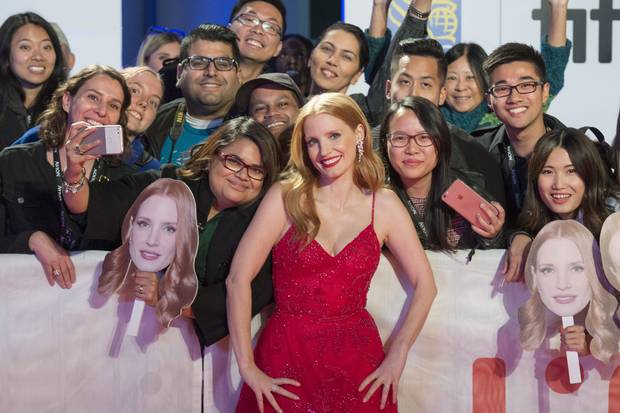 Jessica Chastain poses with fans as she arrives for the premiere of Woman Walks Ahead.