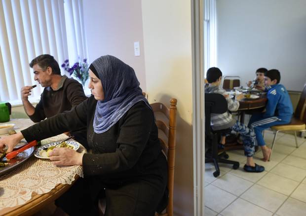 Ahmad Alhaj Ali and his wife Manal Alumoor eat in one room while their three sons eat in the kitchen.
