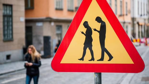Stockholm has erected road signs warning pedestrians against focusing on their smartphones while walking.
