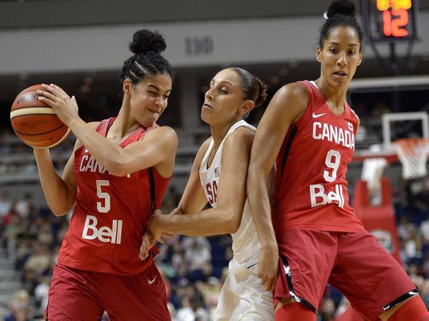 Canada's Kia Nurse, left, keeps the ball from United States' Diana Taurasi, center, as Canada's Miranda Ayim, right, defends, during the first half of an exhibition basketball game, Friday, July 29, 2016, in Bridgeport, Conn. The Canadian women's basketball team has plenty of momentum heading into the Rio Olympics.