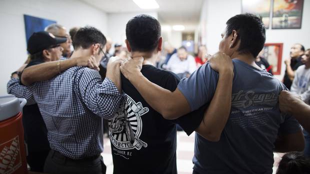Members of the Dudes Club form a circle as they conclude a meeting in Vancouver's Downtown Eastside in October, 2015.