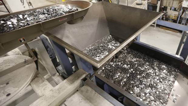 Blanks enter an oven to heated to 800 degree celsius to anneal the metal at the Royal Canadian Mint in Winnipeg Tuesday, April 4, 2017.