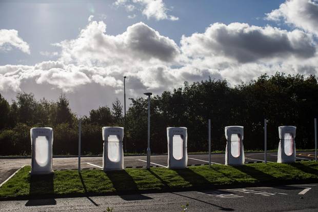 Tesla charging stations wait to be unwrapped at a service station off the M62 motorway near Bradford, U.K.