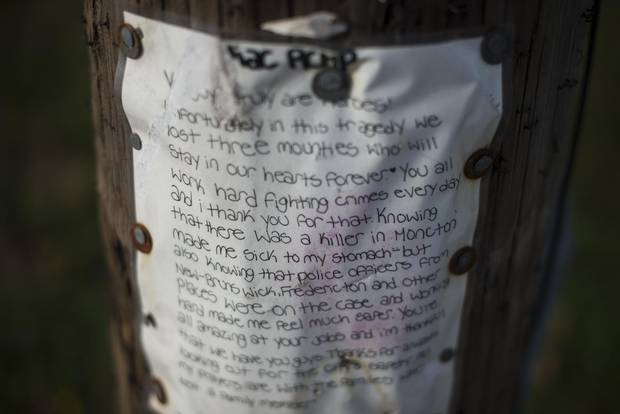 A child's handwritten note remains at the corner of Hildegard Drive and Mailhot Avenue where the three RCMP officers were killed.