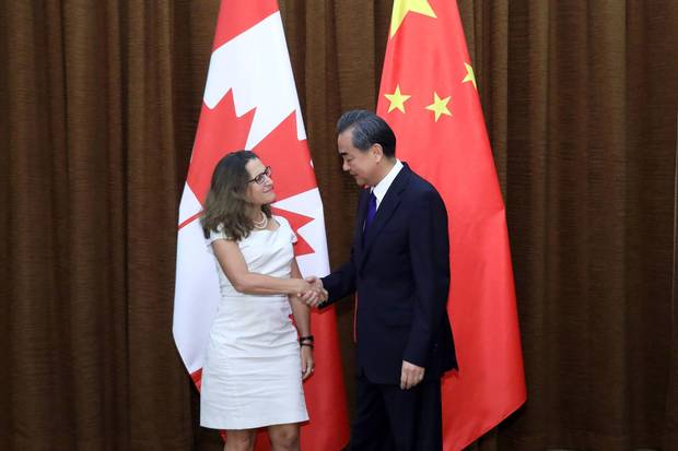 Canada's Foreign Minister Chrystia Freeland (L) shakes hands with her Chinese counterpart Wang Yi as she arrives for a meeting at the Ministry of Foreign Affairs in Beijing on August 9, 2017.