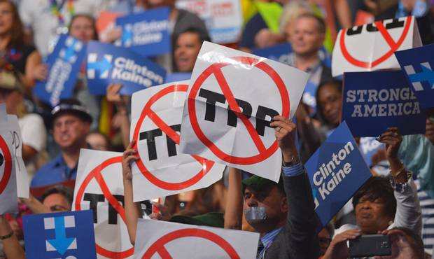 People hold anti-TPP signs at the Democratic National Convention.