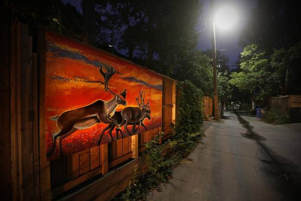 Kal Barteski painted these elk on garage doors in her Wolseley back lane.