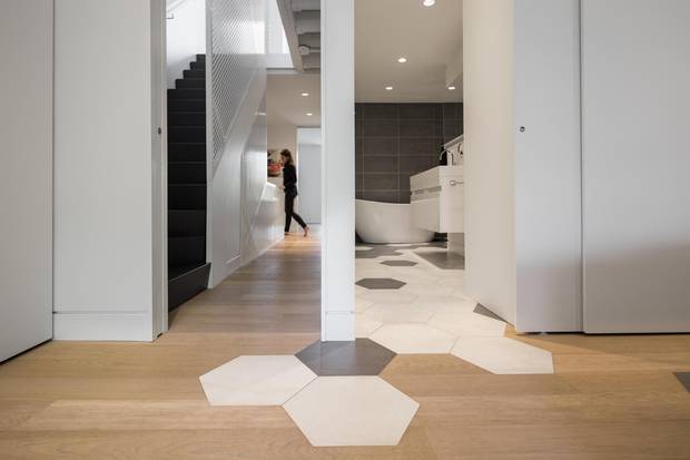 Big hexagonal tiles from the master bath spill out into the bedroom in seemingly random fashion.
