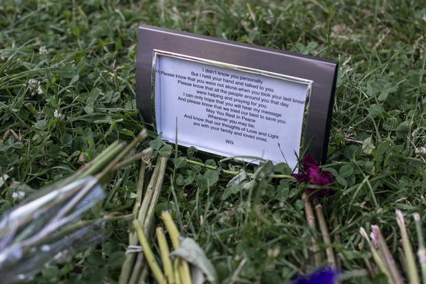 A makeshift tribute has been created at Trinity Bellwoods Park, next to the tree where a man died Friday after being hit by a falling branch, in Toronto, Sunday, June 19, 2016.