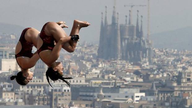 Meaghan Benfeito and Roseline Filion perform during the women's 10-meter platform event at the FINA Swimming World Championships in Barcelona, Spain, on July 22, 2013.