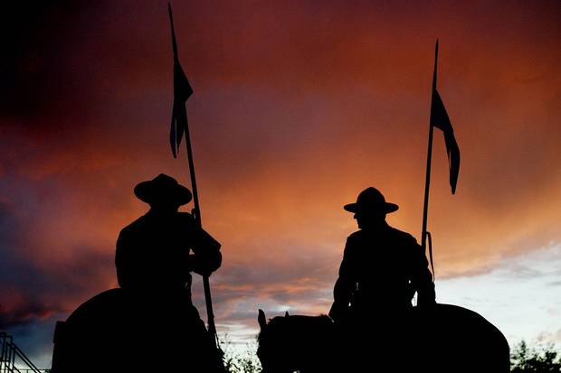 Aug. 30, 2005: Two riders walk off after a special performance of the RCMP Musical Ride in Mayerthorpe, Alta. The western provinces rely on the RCMP for their policing needs, with B.C. laying claim to more than a third of all Mounties.