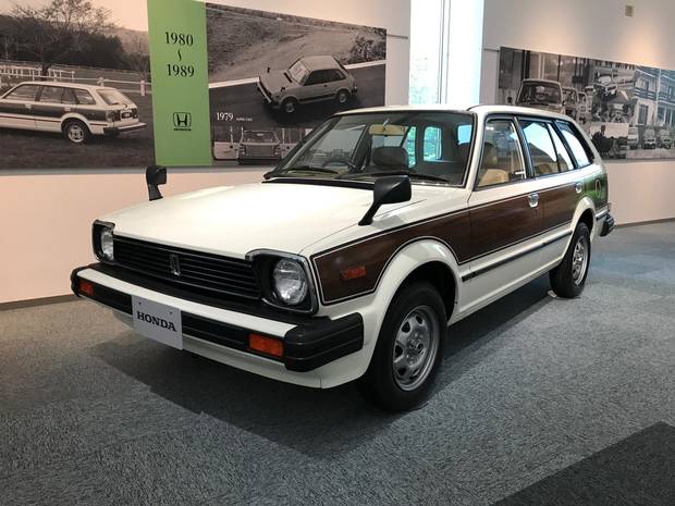 A mid-1980’s Honda Civic featuring wood panelling and a hatchback.