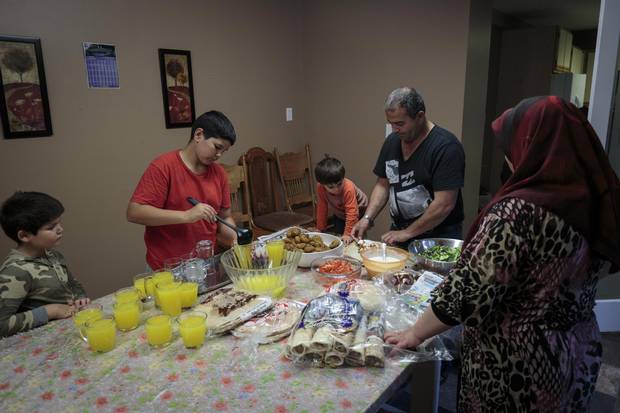 Mohammad and Widad prepare falafel sandwiches with the Hamam children as they wait for guests to arrive to Hussein's first birthday party.