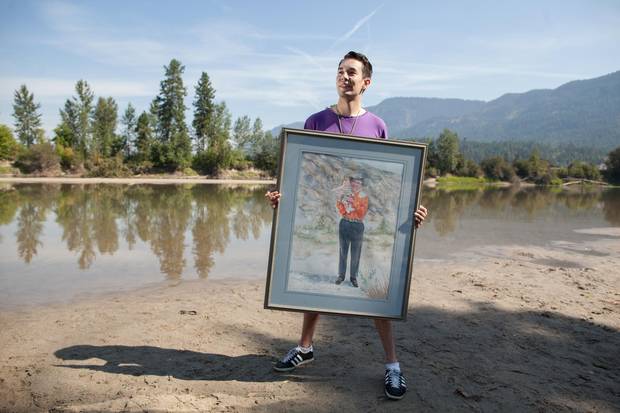 Aaron Leon Williams holds a portrait of Splatsin Elder 