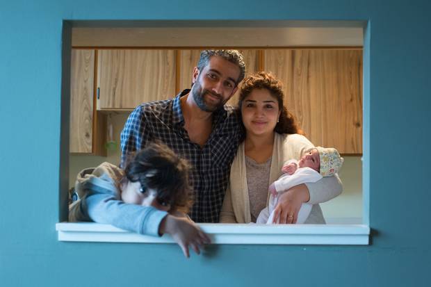 Rami Albarko and his wife, Salma Shaker, are shown at their Vancouver home with their daughters, two-year-old Lilyan, left, and two-week-old Rosel. The Syrian refugees are a government-sponsored family who have been housed and supported by a private sponsorship group since arriving in Canada.