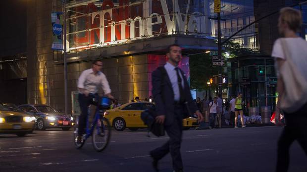 Pedestrians walk near the Time Warner Center in New York City in 2014.