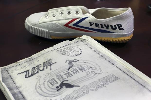 Designer Amy Li prepares Feiyue sneakers for sale in Shanghai. The decades-old brand has seen a revival in China after being imitated by a French company.