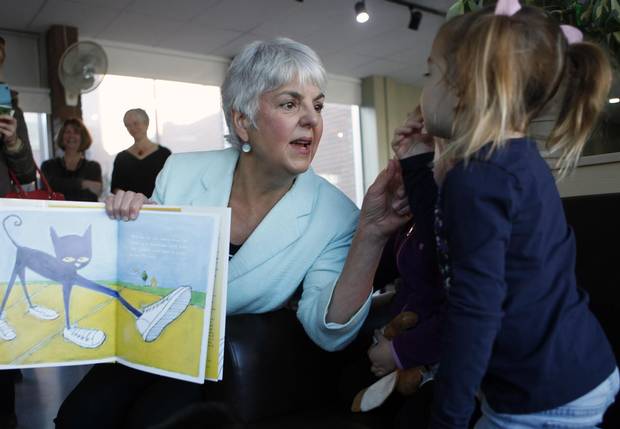 Finance Minister Carole James reads Pete the Cat, I Love My White Shoes to students at the Downtown Y Child Care Centre in Victoria on Feb. 19, 2018.