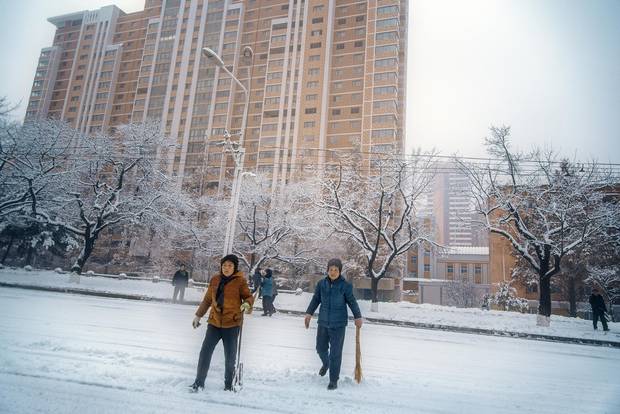 After an overnight snowfall, families and residents take to the streets on a Sunday morning with improvised shovels. North Koreans take their civic duty seriously – everyone pitches in – lending streets like this the air of a city-wide social gathering. Despite few snowplows, major roadways and public spaces are always clear by noon.