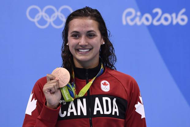 Canada's Kylie Masse poses with her bronze medal on the podium of the Women's 100-metre Backstroke at the Rio 2016 Olympic Games in Rio de Janeiro on August 8, 2016.