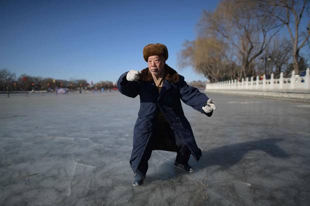 Jan. 23, 2018: In Beijing, under clear blue skies, an elderly man practices tai chi on the frozen lake of Hou Hai.